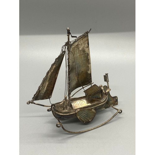 155 - Dutch silver model boat and sailor.