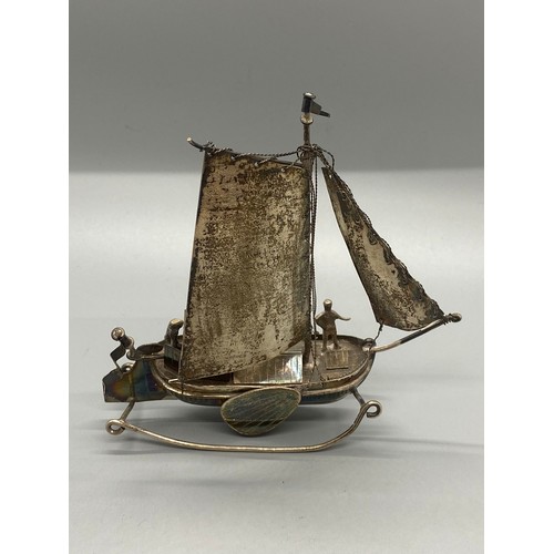 155 - Dutch silver model boat and sailor.