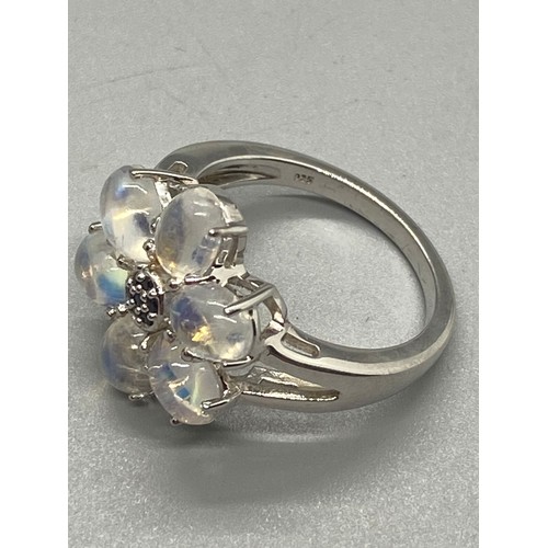 163 - 925 silver and moon stone flower ring.