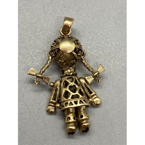 142 - 9ct gold gem set rag doll pendant. 3.12g