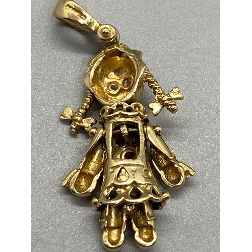 143 - 9ct gold and gem set rag doll pendant. 3.39g