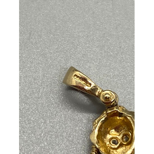 143 - 9ct gold and gem set rag doll pendant. 3.39g