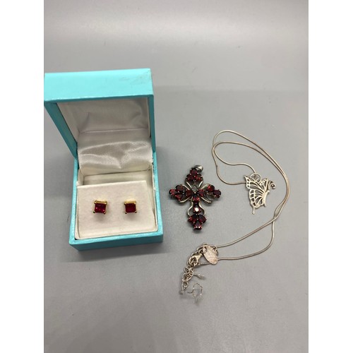 97 - Silver and gem set cross pendant, silver butterfly pendant and chain along with costume earrings.