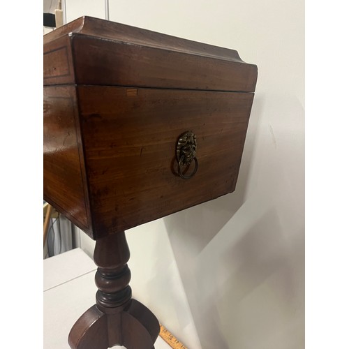 28 - Regency mahogany teapoy, of sarcophagus form, raised on a turned column and tripod base with key.
74... 