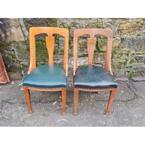 507 - pair of heavy oak green leather arts and crafts chairs.