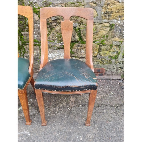 507 - pair of heavy oak green leather arts and crafts chairs.