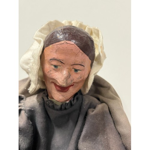 42 - A 19th Century puppet of an elderly lady seated, Dated 1840. 
32cm h