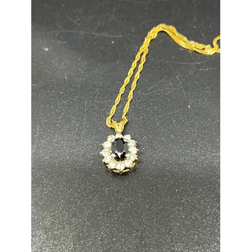 246 - 14ct gold chain along with 9ct gold pendant with blue & white stones.