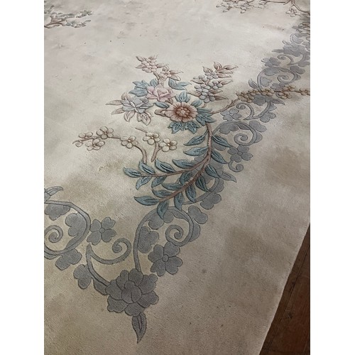 175 - A Large Chinese inspired Neutral wool rug. 
approx [370x273cm] 12ftx9ft