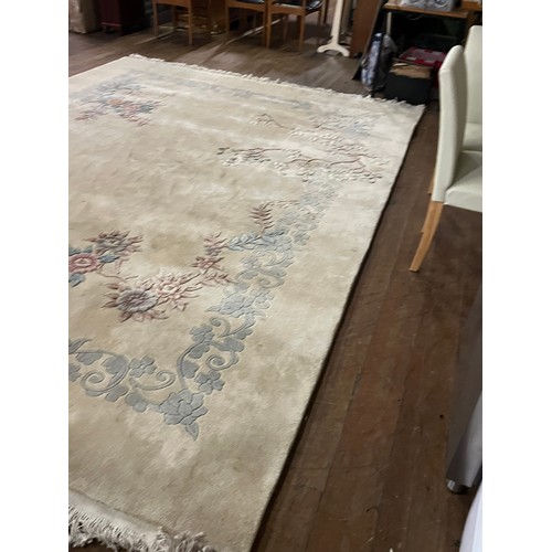 175 - A Large Chinese inspired Neutral wool rug. 
approx [370x273cm] 12ftx9ft