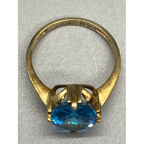 7 - 9ct yellow gold and blue topaz ring.