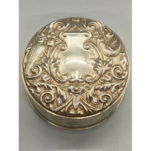 104 - Large Ornate Birmingham silver round lidded jewel box. lid depicts birds, flowers, and green man fac... 