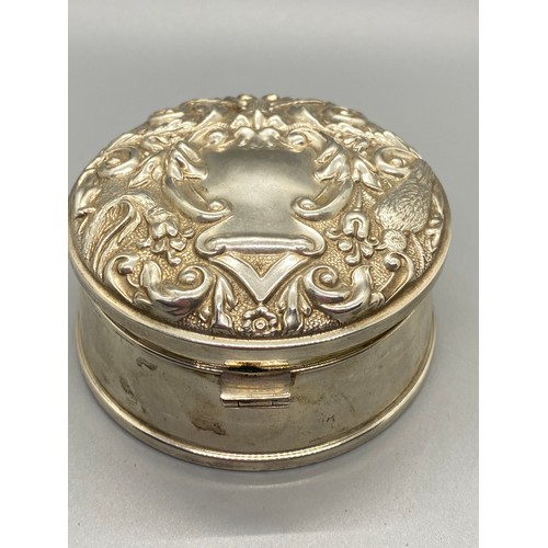 104 - Large Ornate Birmingham silver round lidded jewel box. lid depicts birds, flowers, and green man fac... 