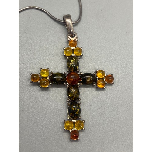 105 - Silver and amber cross pendant and chain along with 2 silver and amber pendants