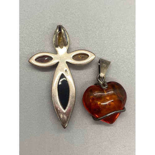 105 - Silver and amber cross pendant and chain along with 2 silver and amber pendants