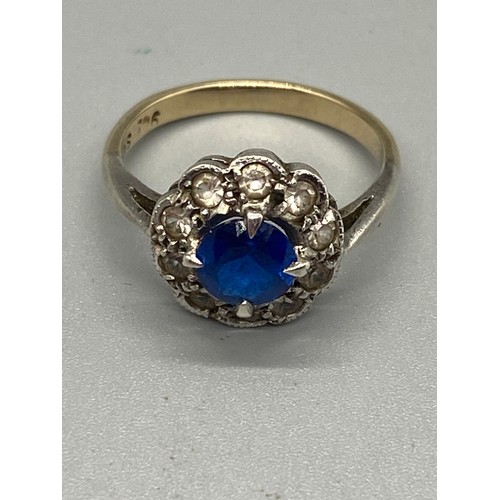 264 - 15ct gold and silver mounted blue and white stone daisy ring.