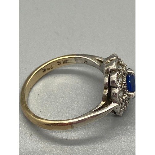 264 - 15ct gold and silver mounted blue and white stone daisy ring.