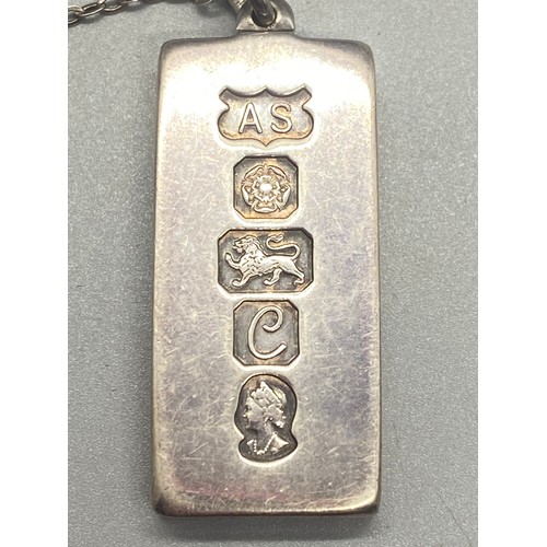 282 - Silver ingot pendant and silver chain. 33.74g