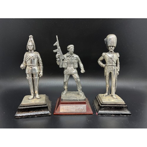 242 - 3 metal soldiers on stands