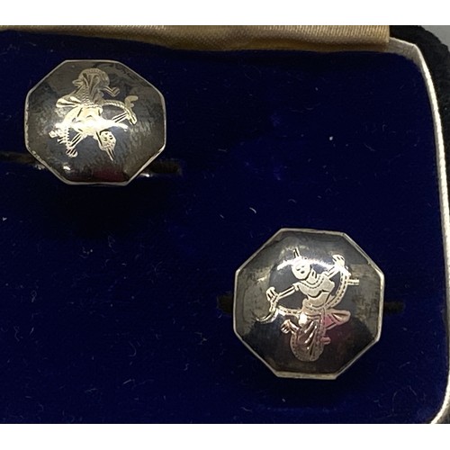 83 - Pair of Siamese silver cuff links.