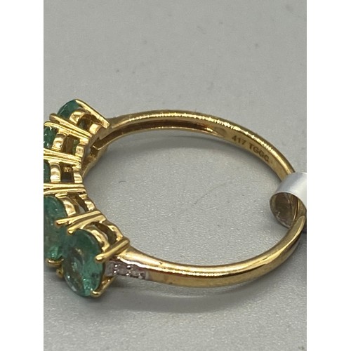 10 - 10k yellow gold, emerald and diamond 5 stone ring.