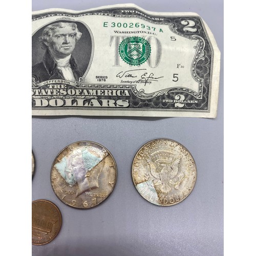 141 - Two dollar note along with 4 x 1967 Kennedy half dollar coins and 1968 Lincoln memorial 1 cent.