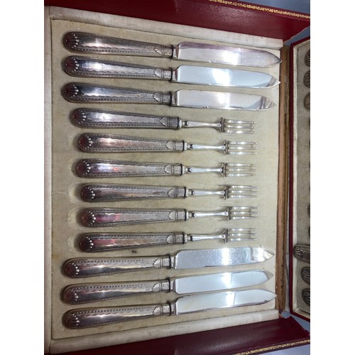 167 - Antique red leather canteen chest contains Sheffield silver handled forks and knives.