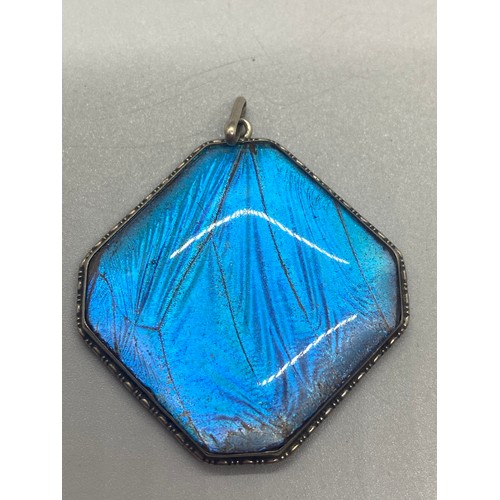 238 - Silver and blue enamel locket pendant and silver and blue butterfly pendant.