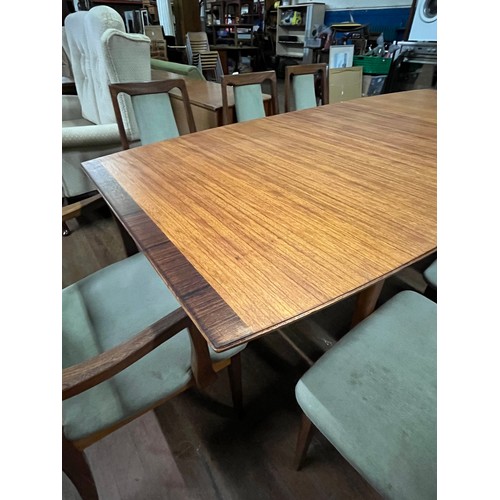 215 - McIntosh teak & rosewood extending table along with 8 G Plan rosewood chairs to include 2 carvers.