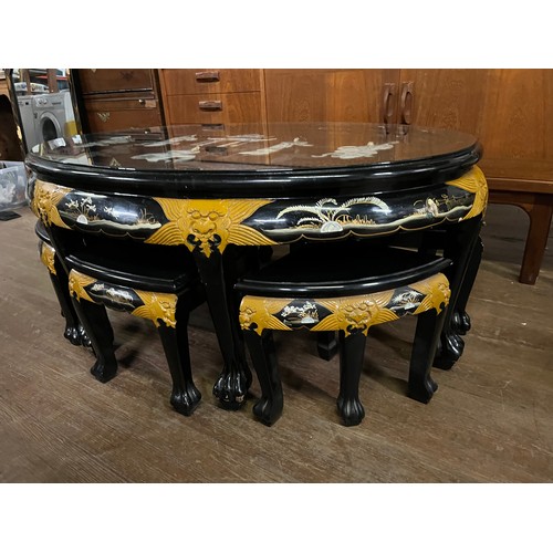 66 - Oriental black lacquered oval coffee table with mother of pearl inlay with 6 stools.
table 120cm x 5... 