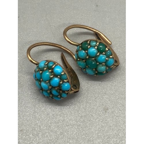 55 - Pair of gold and turquoise earrings and pair of gold and garnet earrings.