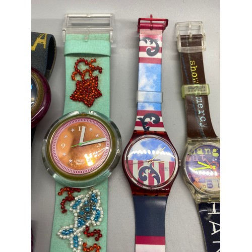 69 - Collection of 11 Swatch watches.