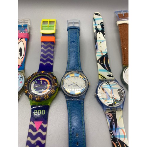 69 - Collection of 11 Swatch watches.