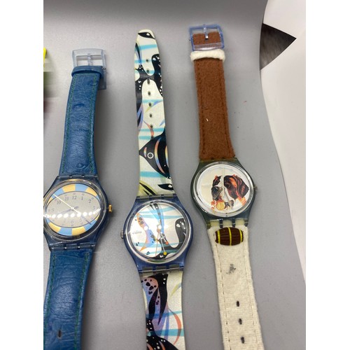 69 - Collection of 11 Swatch watches.