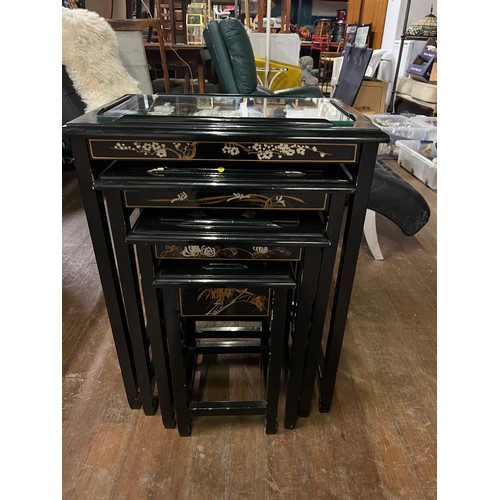 137 - a nest of black laquered oriental tables with mother of pearl inlay