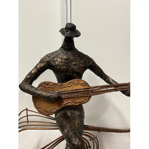 152 - large bronze style sculpture of a guitar player on wooden base 48cm tall