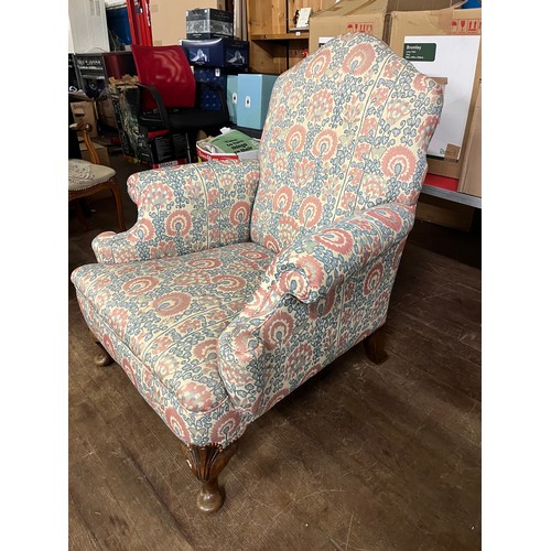 30 - Antique fireside arm chair, raised on short cabriole legs, with matching arm covers.