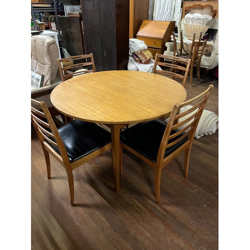 260 - Mid century round table & 4 vinyl ladderback chairs.