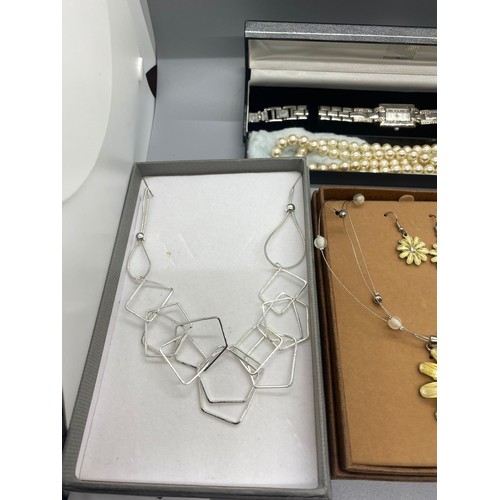 58 - 3 boxed costume necklace sets along with ladies constant wrist watch and set of pearls.