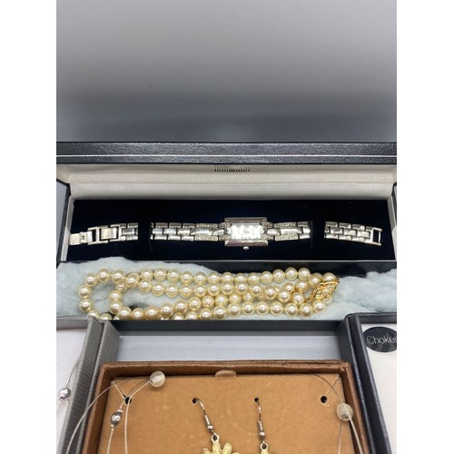 58 - 3 boxed costume necklace sets along with ladies constant wrist watch and set of pearls.