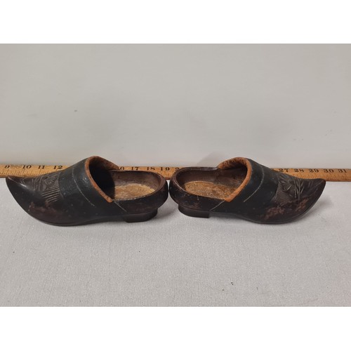 135 - A pair of antique wooden clogs