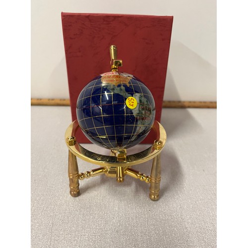 49 - Small gem stone inlay globe on brass stand boxed. 
16cm h