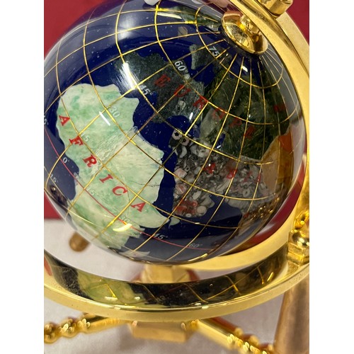 49 - Small gem stone inlay globe on brass stand boxed. 
16cm h