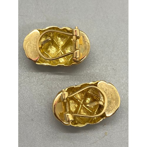 194 - a pair of 18ct gold earrings. 6.25g