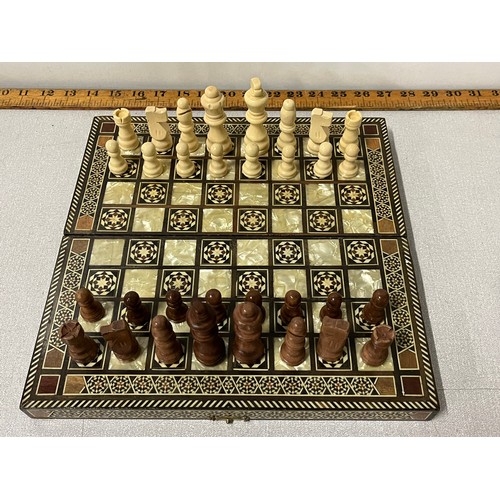 22 - Inlaid chess board with carved chess pieces.