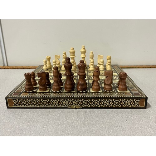 22 - Inlaid chess board with carved chess pieces.