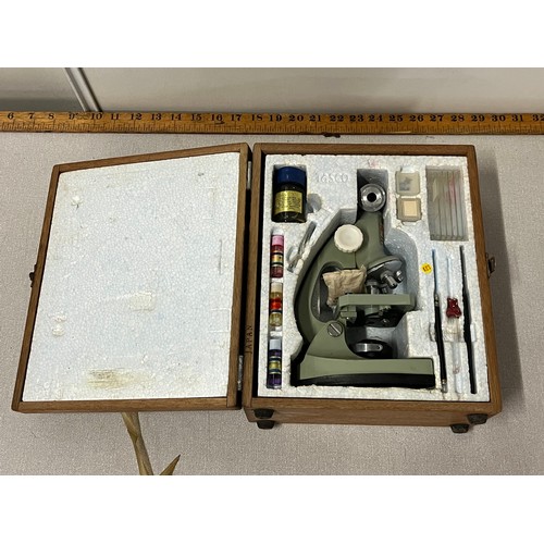 25 - Vintage Tasco Deluxe microscope in original wooden case with accessories.