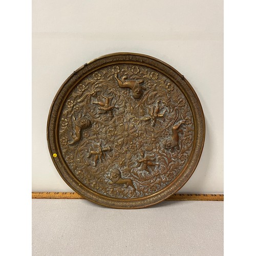 38 - Brass/copper tray decorated with lions and cherub. 44cm in diameter.