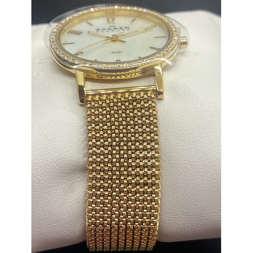 145B - New Skagan ladies wrist with mother of pearl face. Comes with box and booklet.