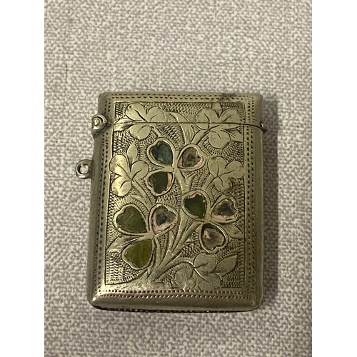 386 - White metal cigarette case along with white metal Vesta case decorated with shamrocks.